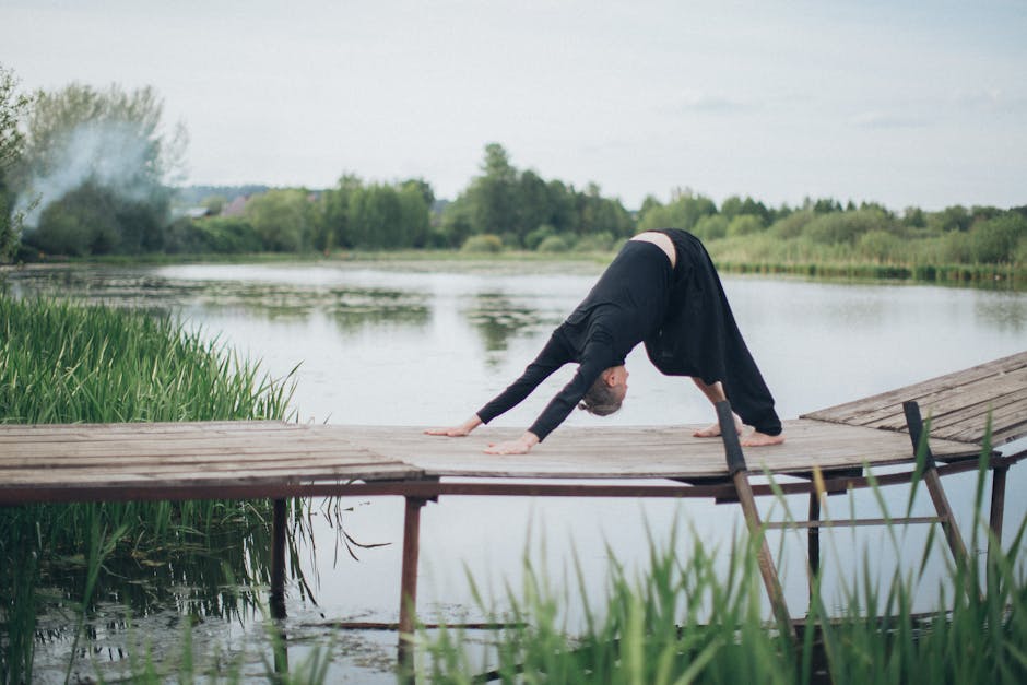 A content man meditating on a wooden pier next to a calm lake, showing a state of mindfulness